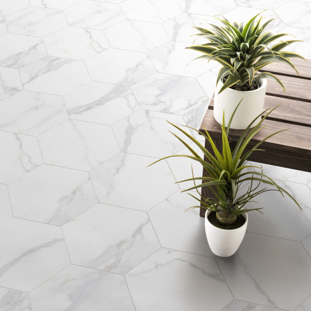 Two potted plants sitting on a marble floor.