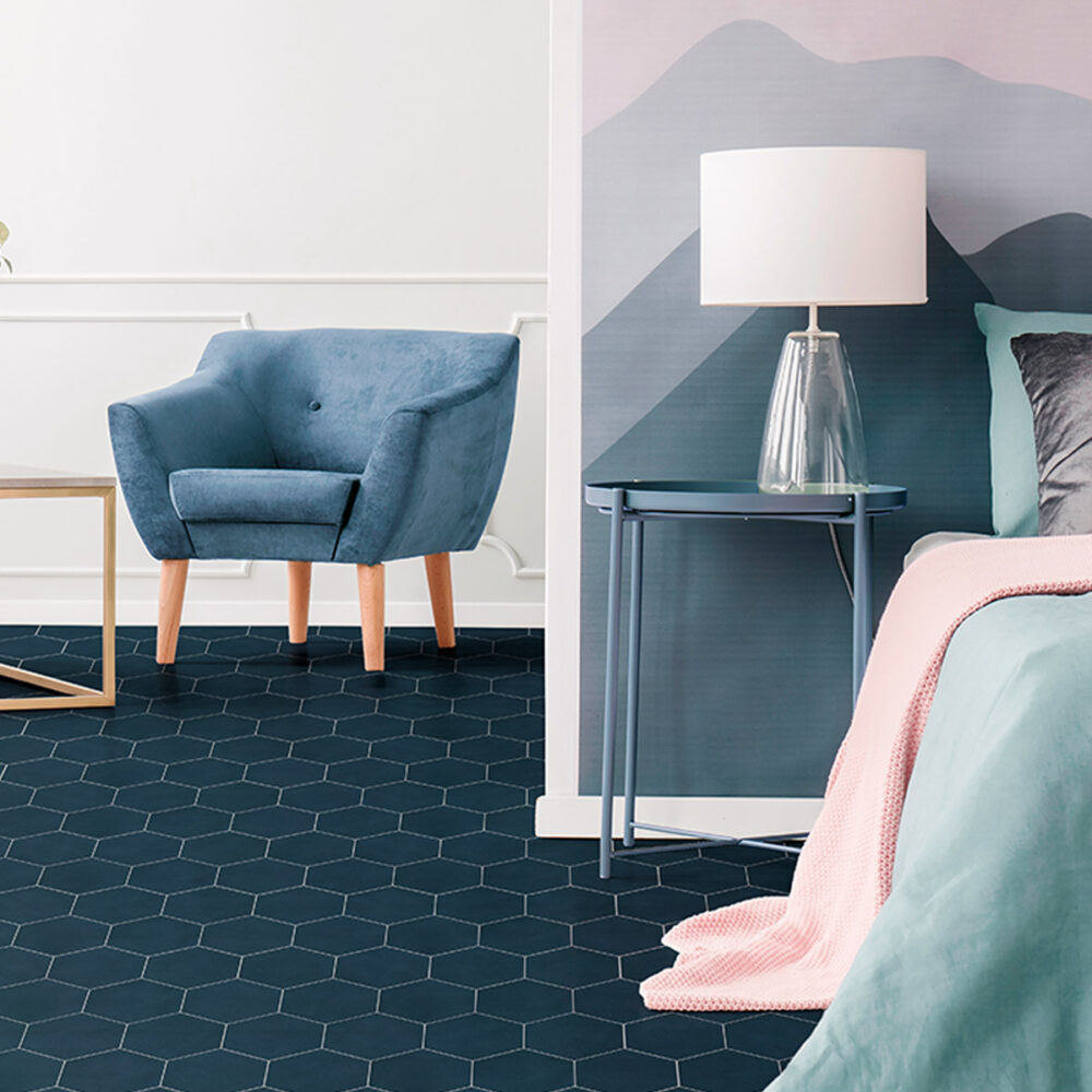 A bedroom with blue walls and pink accents.