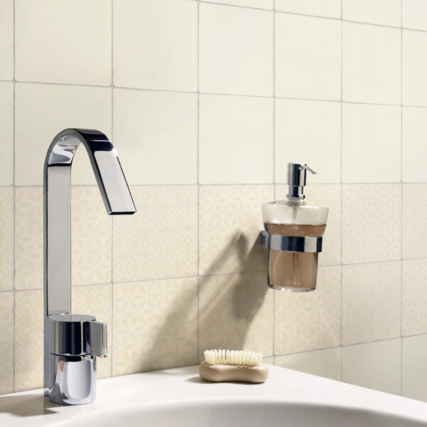 A bathroom sink with soap and toothbrush holder.