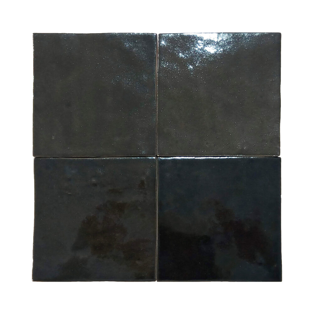 A black tile floor with four different colors of tiles.