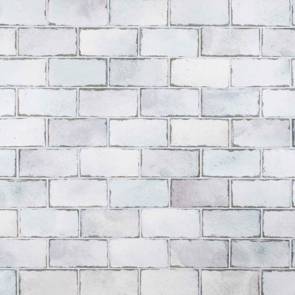 A white brick wall with some gray paint on it