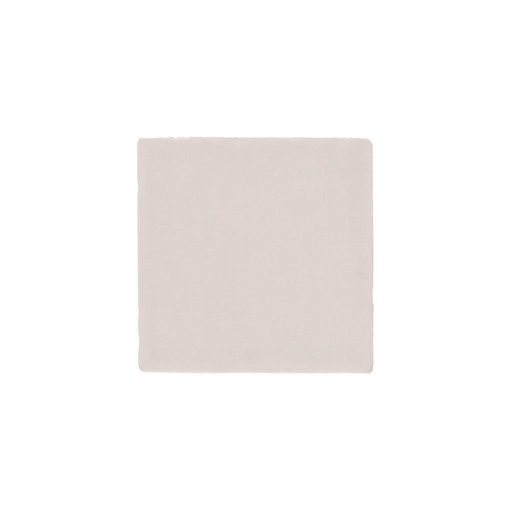 A square white tile sitting on top of a floor.