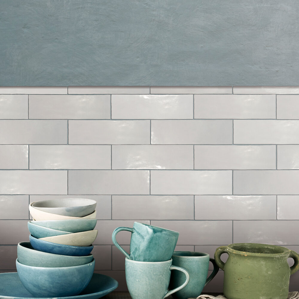 A kitchen with cups and plates on the counter