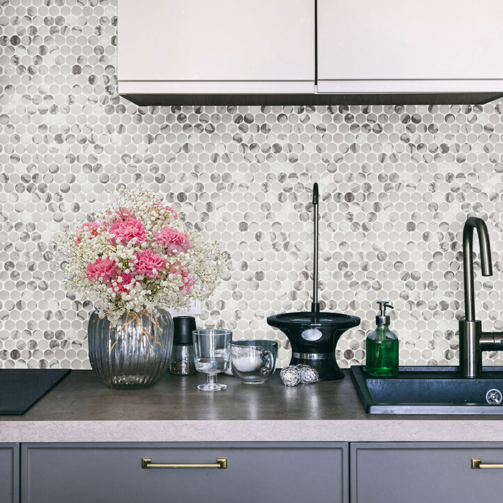 A kitchen counter with flowers and sink in it