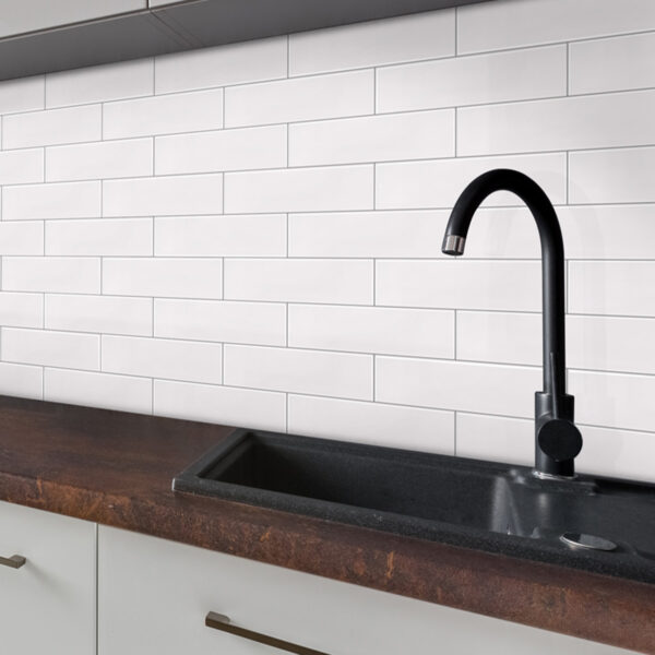 A black faucet sitting on top of a wooden counter.