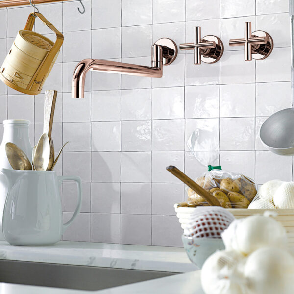 A kitchen with white tile and a sink