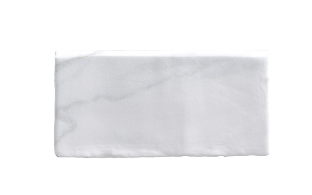 A white tile with some type of marble