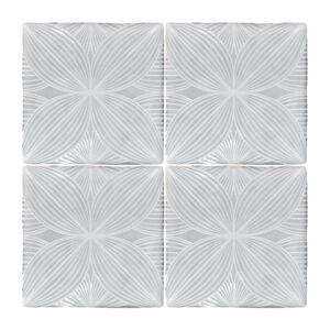 A white tile floor with four different designs.