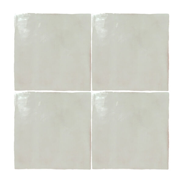 A set of four white tiles with a square design.