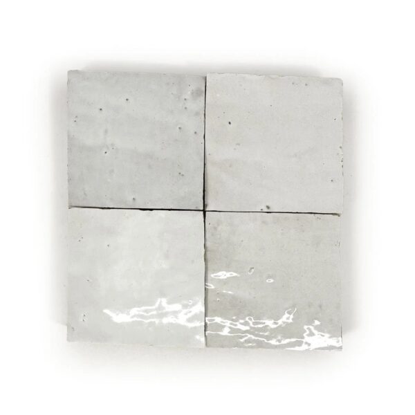 A white tile with four squares on it.