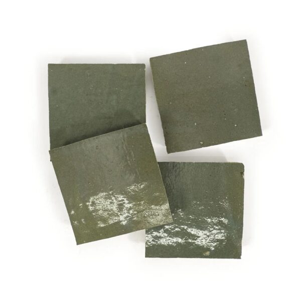 A group of four pieces of green paper.