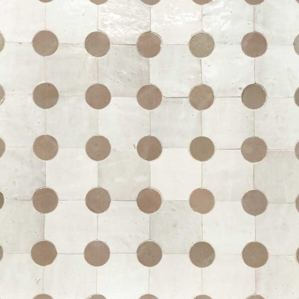 A white tile floor with brown dots on it