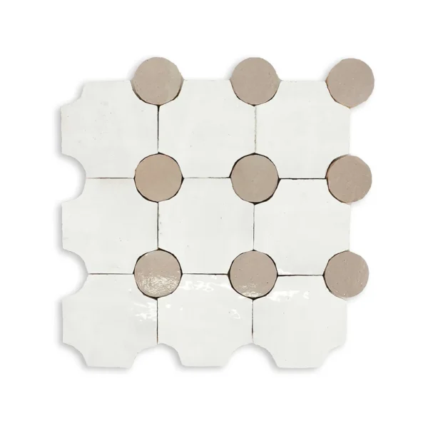 A white tile with brown dots on it