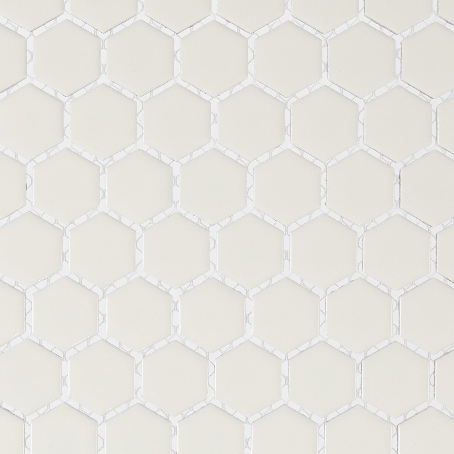 Close-up of white hexagonal tile pattern with subtle grout lines.
